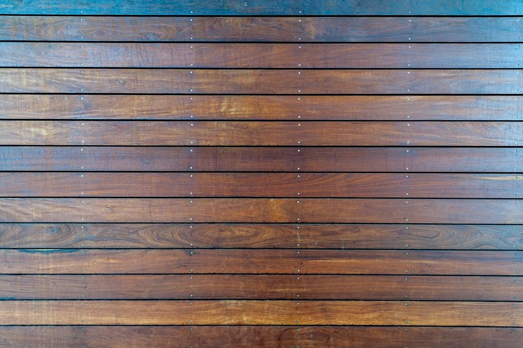 Freshly stained hardwood deck boards seen from above