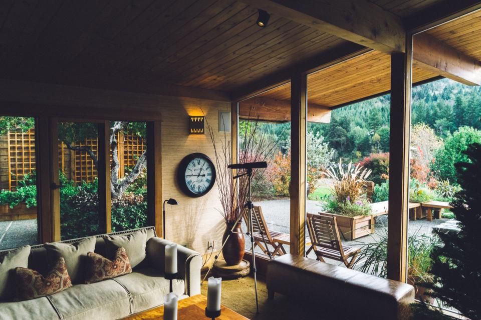 Porch living area with wooden chairs and plants